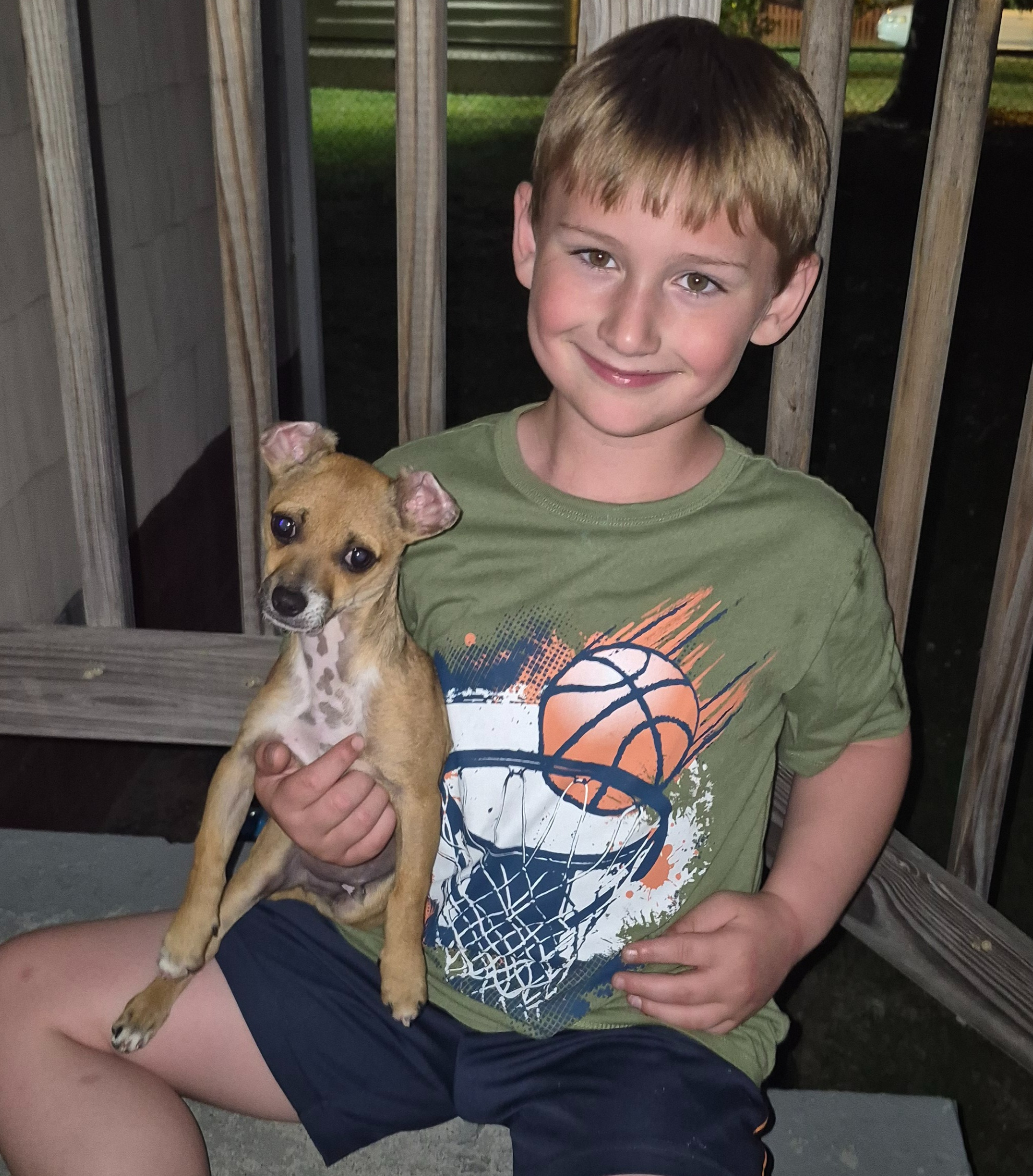 Little boy sitting with a puppy